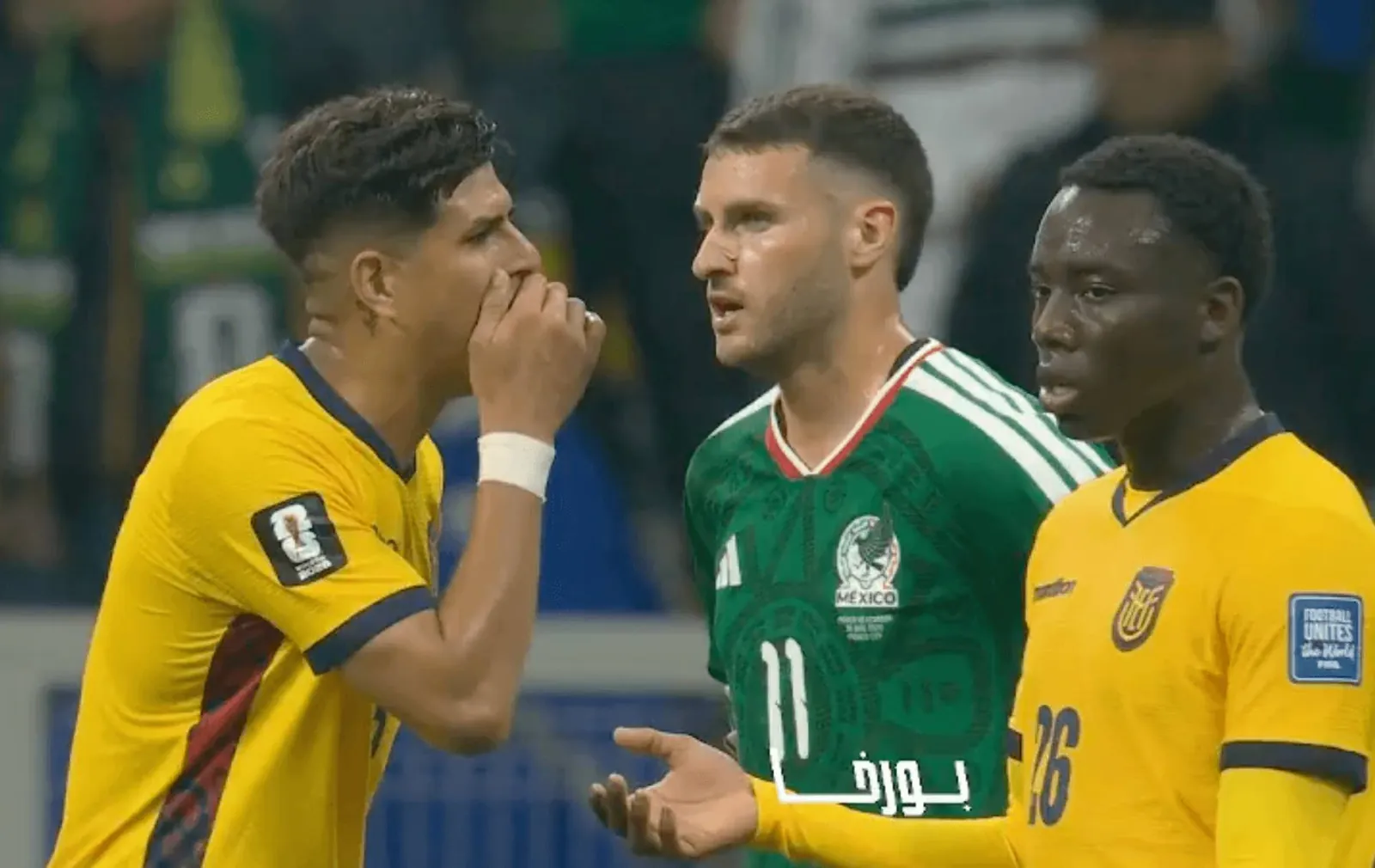 Piero Hincapie shown covering his mouth and talking to Santiago Gimenez
