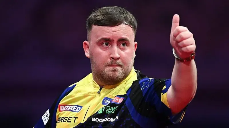 Luke Littler gives a thumbs up towards the crowd during his quarter-final against Josh Rock at the World Matchplay at the Winter Gardens in Blackpool