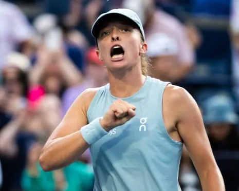 Iga Swiatek pumps her right fist.